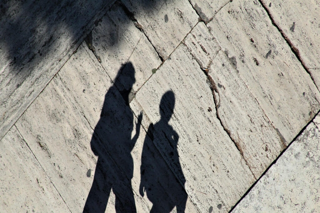 two shadows of people walking